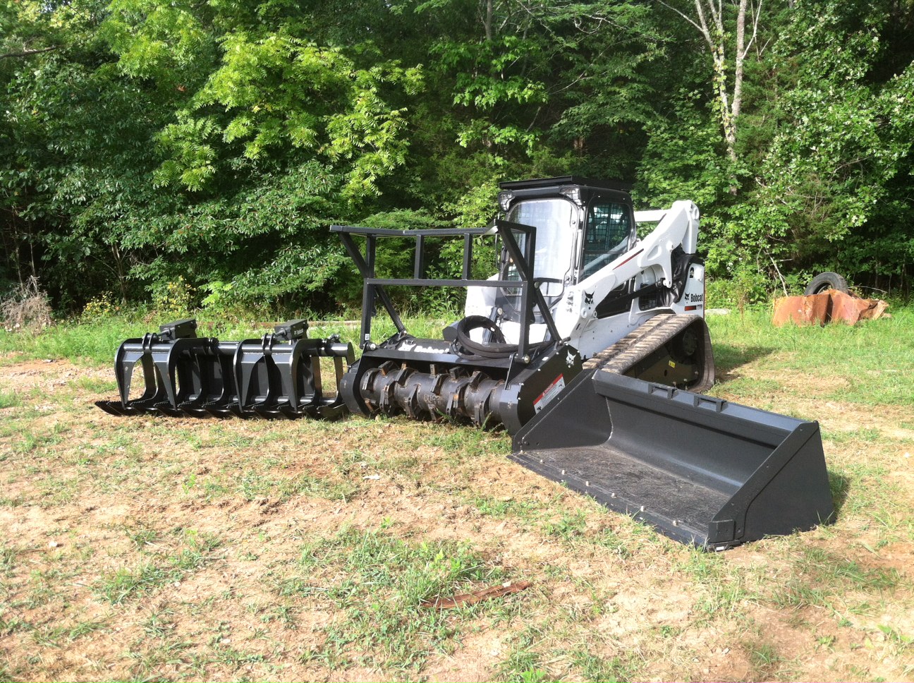 Original Bobcat T770 forestry mulching setup with mulcher, grapple, and bucket attachments in 2014.